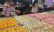 People purchase traditional Indian sweets at a sweet shop for the upcoming festival of Diw...