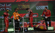 Carlos Sainz (Ferrari, 1st place), Lando Norris (McLaren, 2nd place), and Charles Leclerc...