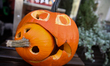 Halloween decorations in the form of carved pumpkin lanterns are seen in a store window in...