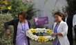 Nepalese people hold bouquet flower to offer homage towards decreased ones, who died in la...