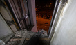 A shattered window frames people in the street outside the 1930s Derzhprom building, which...