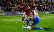 Malvind Benning of Shrewsbury Town FC tackles Kyrell Malcolm of Salford City FC during the...