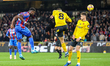 Marc Guehi of Crystal Palace heads the ball towards the goal as Joao Gomes of Wolves tries...