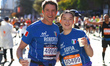 Roberto and Sofia Cere of Italy pose for a photo at mile 16 as they head up First Avenue d...