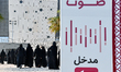 Qatari women arrive at a polling station in Doha, Qatar, on November 5, 2024, to cast thei...