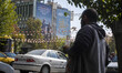An anti-U.S. and Israeli banner hangs from a wall of a governmental building in downtown T...