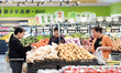 Customers buy potatoes at a supermarket in Renhuai, China, on November 9, 2024. 