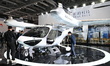 Visitors visit the Tcab Tech booth at the ''Future Low Altitude Travel'' area of the Autom...