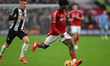 Ola Aina of Nottingham Forest is under pressure from Harvey Barnes of Newcastle United dur...