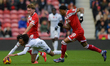 Aidan Morris of Middlesbrough and Tahith Chong of Luton Town tangle for the ball during th...