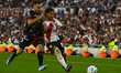 Milton Casco of River Plate competes for the ball against Maximiliano Puig of Barracas Cen...