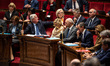 Michel Barnier and government ministers sit among the parliamentary benches during questio...