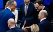 German Chancellor Olaf Scholz greets opposition leader Friedrich Merz before a plenary ses...