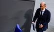 German Chancellor Olaf Scholz leaves the speaker's podium after delivering a Government De...