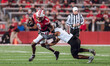 Wisconsin Badgers wide receiver Vinny Anthony II #8 tries to escape a tackle against the O...