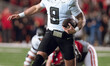 Oregon quarterback Dillon Gabriel #8 scrambles against the Wisconsin Badgers at Camp Randa...