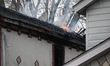Flames come from the home on Sunday afternoon in Queens Village. One person is killed in a...