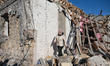 In the Odesa region, Ukraine, on November 17, 2024, a woman walks along a house destroyed...