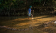 An old tribal man walks through the reservoir, locally called ''Jhiri,'' in Durgapur, Netr...