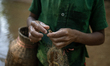 Indrajit (11) catches fish from the reservoir with a small net to support his family in Du...