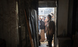 Palestinians wait in a queue to receive bread outside a bakery in Khan Yunis, on November...