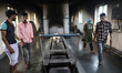 Tumpa Das, age 29, prepares a dead body for cremation in a furnace inside a crematorium in...