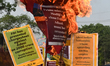 Congress party workers hold placards and burn an effigy during a protest demanding the arr...
