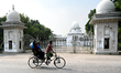 A rickshaw puller rides in front of the high court in Dhaka, Bangladesh, on November 23, 2...