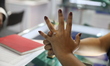 A woman looks at diamond jewelry rings inside a stall at East India's International Gems a...
