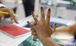 A woman looks at diamond jewelry rings inside a stall at East India's International Gems a...