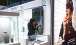 A worker arranges diamond jewelry inside a stall at East India's International Gems and Je...