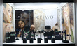 A worker arranges diamond jewelry inside a stall at East India's International Gems and Je...