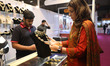 A trader displays diamond jewelry to a customer inside a stall at East India's Internation...