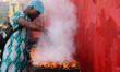 A man prepares chicken during the 10-kilometer Capital City Race 2024 in Ikeja, Lagos, Nig...