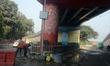 People walk on the foot over bridge during smoggy conditions in New Delhi, India, on Novem...
