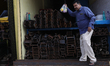 A trader comes out from his shop at a wholesale steel and iron market in Kolkata, India, o...