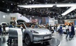 Visitors inspect an AION HYPTEC HT electric car displayed at the Thailand International Mo...