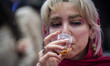 A young Iranian woman tastes a coffee while visiting the Iran Coffee Expo at the Iran Mall...