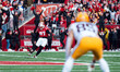 Wisconsin Badgers kicker Gavin Lahm #97 drives the opening kickoff deep into Minnesota Gol...