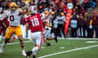 Wisconsin Badgers quarterback Braedyn Locke #18 throws a pass against the Minnesota Golden...