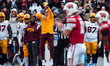 Minnesota Golden Gopher head coach P.J. Fleck jumps to signal a false start against the Wi...