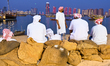 Traditional Arabic fishermen rest after a performance at the 14th Katara Traditional Dhow...