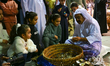 A Qatari man opens an oyster and extracts pearls during the 14th Katara Traditional Dhow F...
