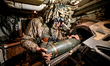 An artilleryman of Ukraine's 118th Separate Mechanized Brigade loads a shell inside a self...