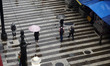 People walk with their umbrellas on a cloudy and rainy day in the center of Sao Paulo, Bra...