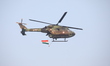 An Indian army helicopter carries an Indian national flag ahead of the full dress rehearsa...