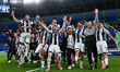 Players of Pachuca celebrate with the trophy after winning the FIFA Challenger Cup Qatar 2...