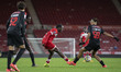 George Gitau of Middlesbrough knocks the ball forward through the legs of Leandro Martins...