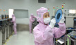 Workers produce automotive semiconductor products at a workshop of an automotive semicondu...