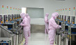Workers produce automotive semiconductor products at a workshop of an automotive semicondu...